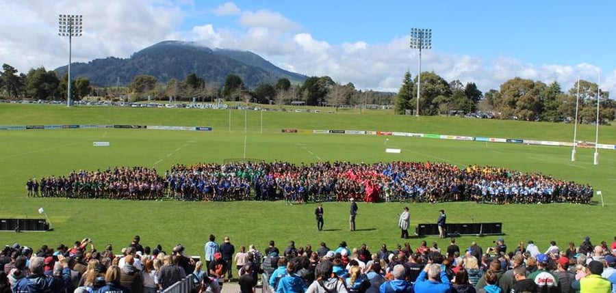 Junior rugby teams gathered on New Zealand rugby field for photos