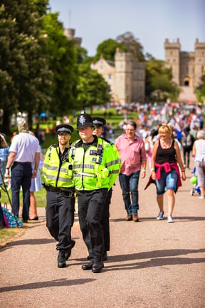 three policemen at an event walking through the crowd